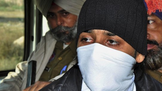 Puneet Puneet, foreground, is escorted by policemen at a district court in Rajpura, in northern India.