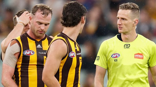 Tom Mitchell speaks with field umpire Hayden Gavine after a 50-metre penalty was awarded.