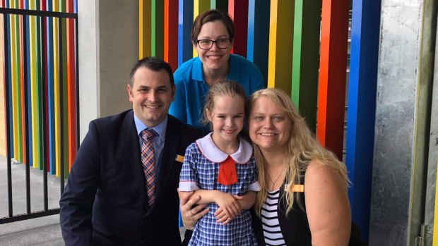 Principal Tom Moth and assistant principal Kasey-Lea McGill (right) welcome a kindergarten student and her mother to North Kellyville Public School.