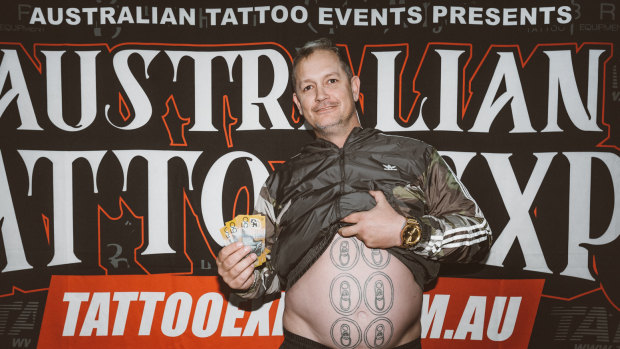 Queenslander Scott Medhurst won a competition at the Australian Tattoo Expo on July 14 for having the worst tattoo, which was a six pack of beers on his stomach.