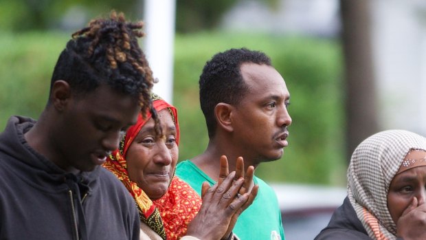 Shocked worshippers emerge from one of the mosques.