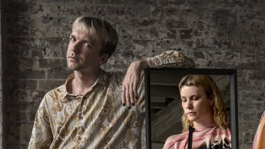 Putting it together. Designer Alix Higgins prepares for his runway debut at Afterpay Australian Fashion Week with model Chloe Corkan.