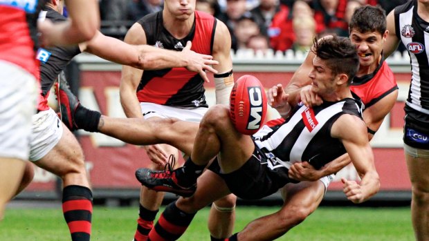 Bombers ruckman Paddy Ryder slings Magpie Sharrod Wellingham to the ground in a tackle.