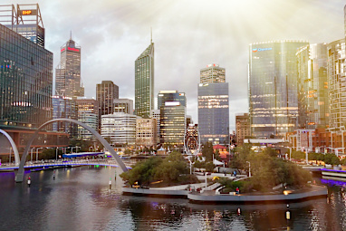 Elizabeth Quay pedestrian bridge in Perth captured at sunset aerial view from flying drone.