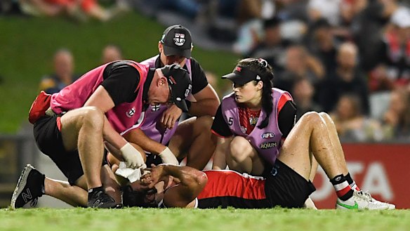 Hunter Clark is attended by medical staff.