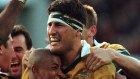 Australian Wallabies captain John Eales, right, is hugged by George Gregan, after kicking a goal to beat the All Blacks in 2000. 