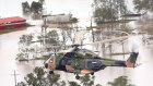 An army helicopter performing search and rescue missions over flood-affected properties in the Ballina region.