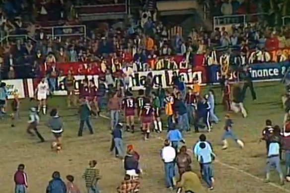 Fans invade the pitch at full-time.