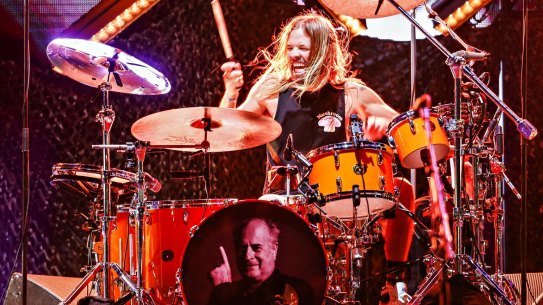 Drummer Taylor Hawkins of Foo Fighters performs onstage with the face of Mushroom Records founder Michael Gudinski on his bass drum at GMHBA Stadium in Geelong.