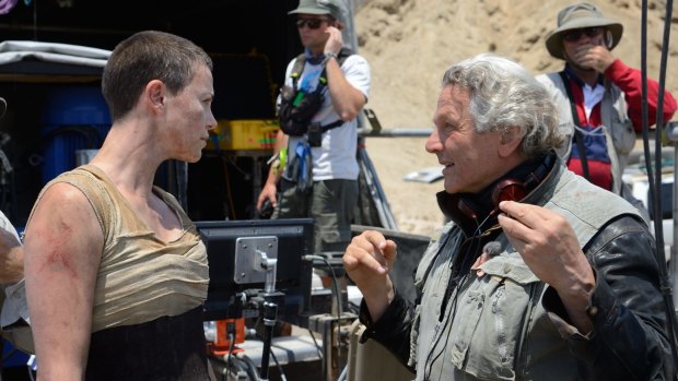 George Miller directs Charlize Theron on the set of Mad Max: Fury Road.