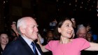 NSW Premier Gladys Berejiklian enters with former prime minister John Howard on election night.