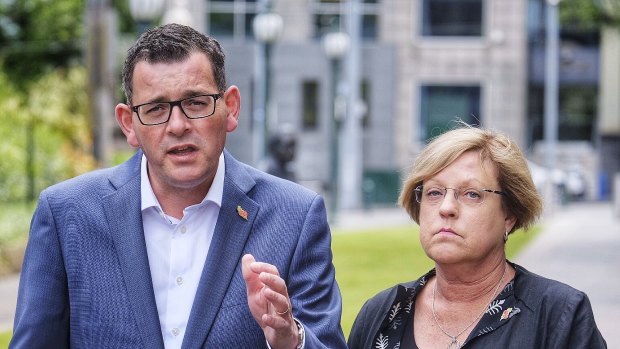 Victorian Premier Daniel Andrews accompanied by Victoria's Police Minister Lisa Neville  give a media conference outside treasury gardens in Melbourne.