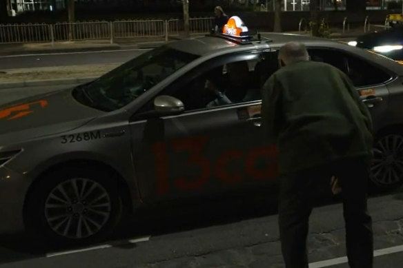 Tennis spectators attempt to get a taxi outside Melbourne Park after the conclusion of play.