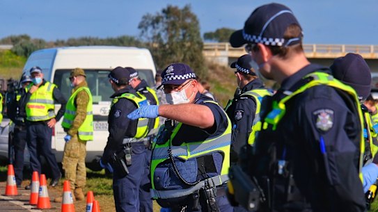 ADF personnel and Victoria Police at a checkpoint on the Princes Freeway on the outskirts of Melbourne.