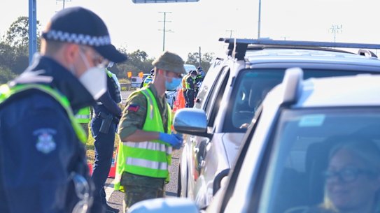 Police and ADF personnel at a checkpoint on Melbourne's outskirts.