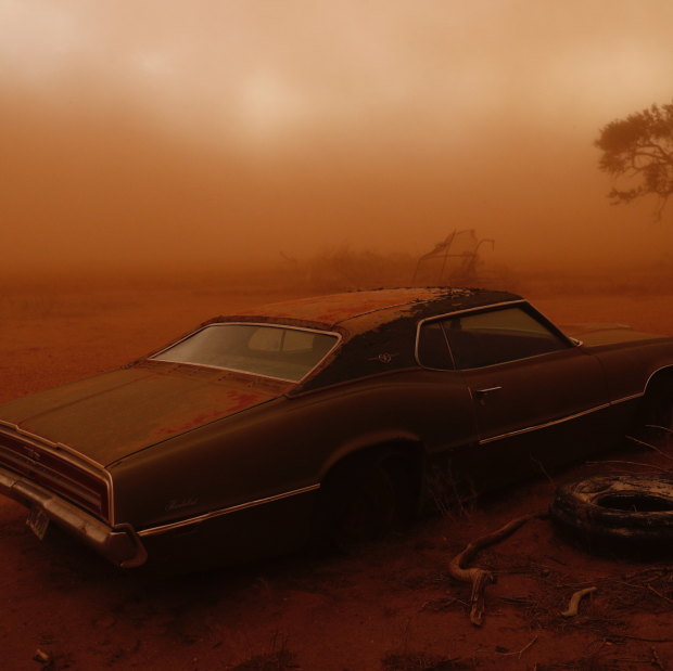  A rusting Ford Thunderbird in Texas is swallowed by red dust created when topsoil is ripped from ploughed fields and lifted into the sky.
