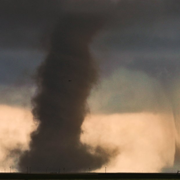 Twin tornadoes dance with each other in eastern Colorado, on a day when a single supercell thunderstorm produced 15 tornadoes.
