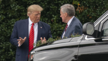 Then US president Donald Trump and his White House chief of staff Mark Meadows, right, talk outside the Oval Office last year.