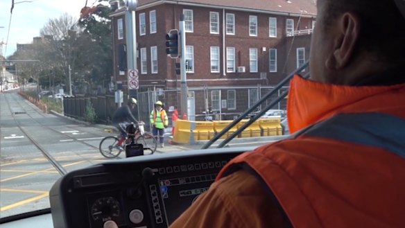 A cyclist cuts in front of a tram.