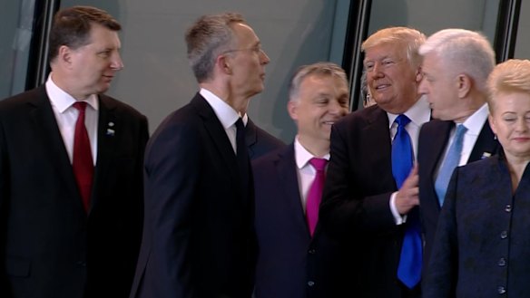 Getting ahead: US President Donald Trump pushes Montenegro Prime Minister Dusko Markovic, second right, at the NATO meeting in Brussels in May, 2017.