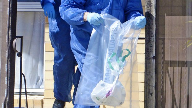 Forensics police remove items from the home of Savas Avan in Shepparton.