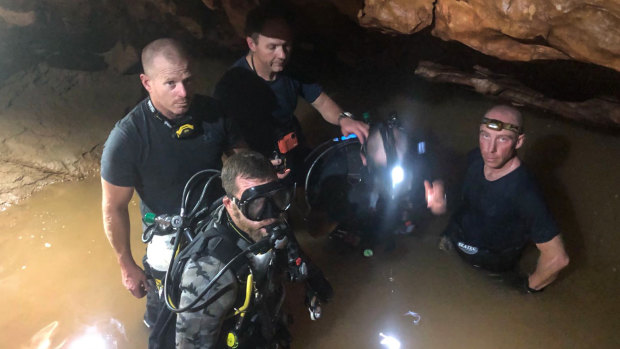 Australian Federal Police specialist response group divers assist in transporting supplies.