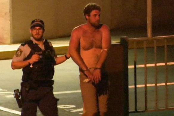 Alleged drink-driver Samuel Davidson is led away by police.