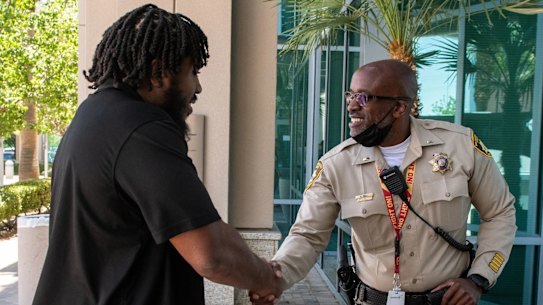 Las Vegas Raiders guard Dylan Parham meets Las Vegas Metropolitan Police Department Lieutenant Kendall Bell. 