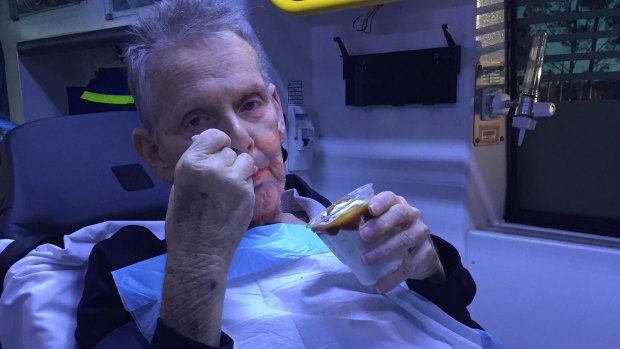 Ron McCartney enjoys a caramel sundae, given to him by ambulance workers.