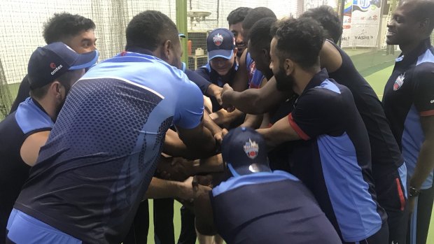 New teammates: Steve Smith (pictured centre with head down) training with his Toronto Nationals ahead of the T20 Canada competition.