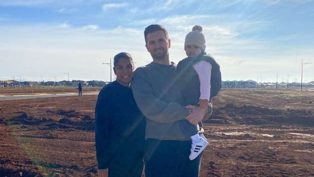 Kim Misic, husband Marko and daughter Ana in front of the site of their build.