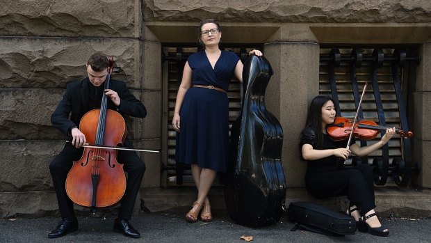 Mia Patoulios, CEO of Sydney Youth Orchestras (centre), with principal cello Alisdair Guiney (left) and principal viola Alison Eom (right) outside the former Registrar-General’s building in Sydney. 