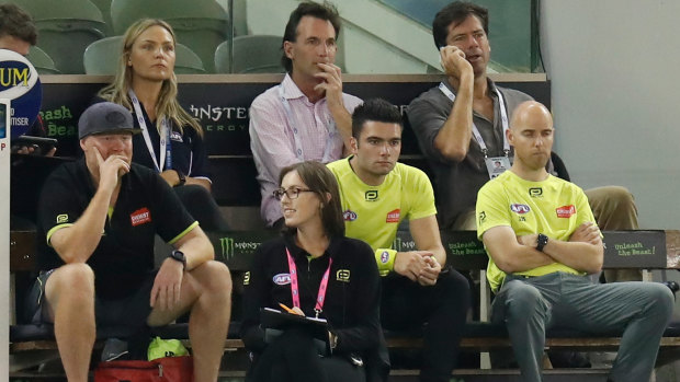 Andrew Dillon and Gillon McLachlan watch close-up a Collingwood-Brisbane game during the 2021 COVID year.