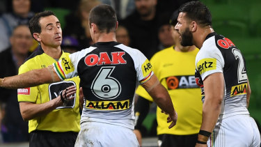 Disputed call: Penrith's James Maloney and Josh Mansour argue with referee Gerard Sutton.