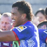 Newcastle players celebrate Edrick Lee’s try against the Warriors.