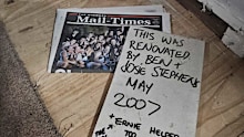 The newspaper and plasterboard message found by Maddi and Josh King.