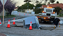 A burst water main is reportedly the cause of the massive sinkhole.