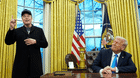 President Donald Trump listens as Elon Musk speaks in the Oval Office.