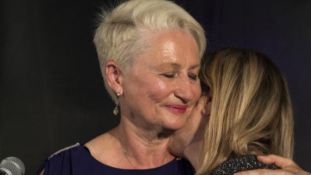 Kerryn Phelps is embraced by her wife Jackie Stricker-Phelps during her victory speech in the Wentworth byelection.