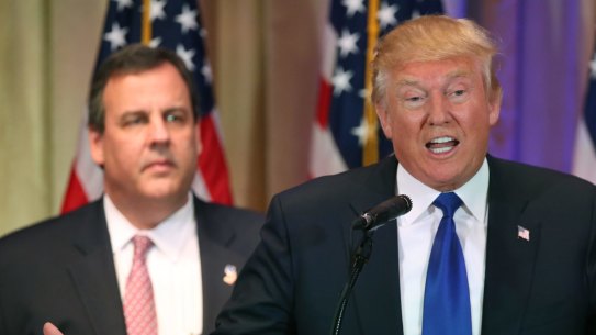 Republican presidential candidate Donald Trump speaks on Super Tuesday primary election night. New Jersey governor Chris Christie looks on.