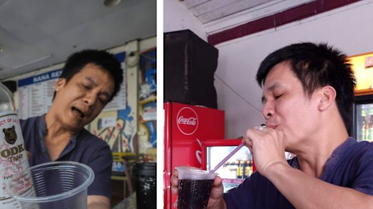 Nana Backpacker Hostel manager Duong Duc Toan pouring himself a drink from a bottle of Tiger Vodka and finishing it.