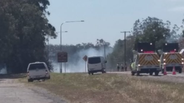 Fire crews back-burn near a service station on Steve Irwin Way.