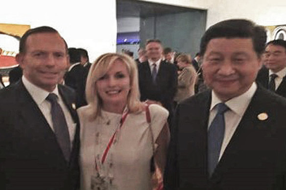 Then prime minister Tony Abbott with Christine Holgate, chief executive of Australia Post, and Chinese President Xi Jinping at the G20 meeting in Brisbane in 2014. The photo was taken on Ms Holgate's smuggled iPhone. 