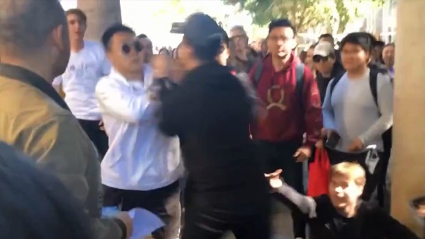 The first punch was thrown when the protest organiser approached two students after one of them stole his megaphone and threw it.