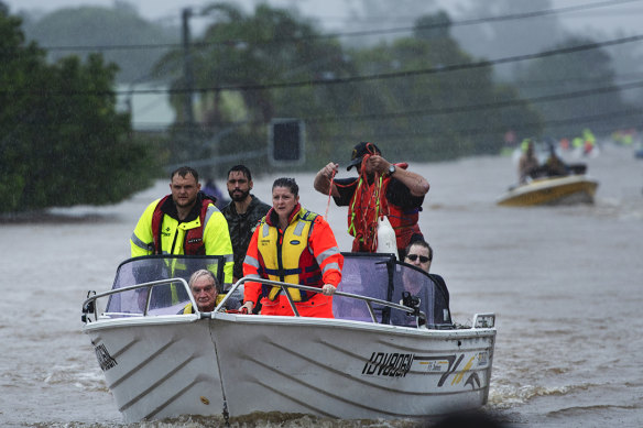 Locals in fishing boats help with rescue efforts in Lismore.