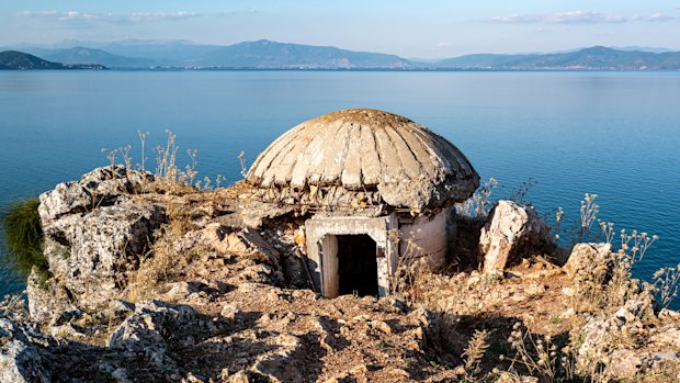 A mushroom-shaped bunker on the rocky shore of Lake Ohrid, Albania.