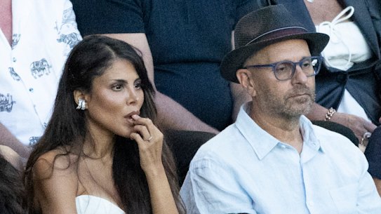Alex Waislitz in a black fedora with fiance Rebekah Behbahani, at left, at the Australian Open men’s final.