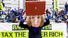 A campaigner wearing a mask of UK Chancellor Rachel Reeves during a protest in London calling for the introduction of a wealth tax.