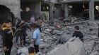 Palestinians inspect damage following an Israeli airstrike in the Shejaiya residential district, east of Gaza City.