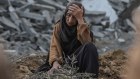 A Palestinian woman among rubble after Israeli shelling in the Nuseirat refugee camp in central Gaza on Friday.